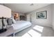 This bedroom features neutral walls, grey carpet, and a king bed with white bedding and a grey upholstered bedframe at 17893 W Indigo Brush Rd, Goodyear, AZ 85338