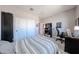 Bright bedroom featuring plush carpet, a large closet with sliding doors, and neutral walls at 17893 W Indigo Brush Rd, Goodyear, AZ 85338