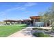 The community center has lush green lawns, modern architecture, and community signage at Estrella at 17893 W Indigo Brush Rd, Goodyear, AZ 85338