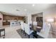 Bright dining room open to the kitchen features a modern table, six chairs, and stylish decor at 17893 W Indigo Brush Rd, Goodyear, AZ 85338