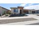 Charming single-story home featuring stone accents, a two-car garage, and low maintenance desert landscaping at 17893 W Indigo Brush Rd, Goodyear, AZ 85338