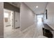 Bright hallway with wood-look tile flooring that connects to the bathroom and living area at 17893 W Indigo Brush Rd, Goodyear, AZ 85338