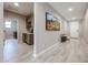 Bright hallway with wood-look tile flooring, featuring a built-in bar and an art display at 17893 W Indigo Brush Rd, Goodyear, AZ 85338