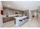 Kitchen with a large island, bar stool seating, stainless steel appliances, and modern finishes at 17893 W Indigo Brush Rd, Goodyear, AZ 85338