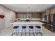 Kitchen with a large island, bar stool seating, stainless steel appliances, and modern finishes at 17893 W Indigo Brush Rd, Goodyear, AZ 85338