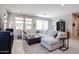 Comfortable living room boasts a large sectional sofa, contemporary furnishings, and a view of the backyard at 17893 W Indigo Brush Rd, Goodyear, AZ 85338