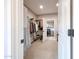 This walk-in closet offers ample storage with clothing racks, shoe shelves, and an adjoining laundry room at 17893 W Indigo Brush Rd, Goodyear, AZ 85338