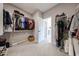 This walk-in closet features clothing racks, shoe shelves, ample space and an adjoining room at 17893 W Indigo Brush Rd, Goodyear, AZ 85338