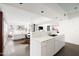 Bright, open-concept kitchen with stainless steel appliances and modern white cabinetry flowing into the living room at 2030 N 17Th Ave, Phoenix, AZ 85007