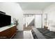 Comfortable bedroom featuring a large window, sleek dresser, and modern decor elements with ample natural light at 2030 N 17Th Ave, Phoenix, AZ 85007