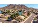 Scenic aerial view of a waterfront residential area surrounded by a lake and beautiful homes with a desert mountain at 20615 N 55Th Ave, Glendale, AZ 85308