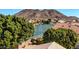 An elevated view of a backyard and lake with trees and greenery and neighborhood near a mountain at 20615 N 55Th Ave, Glendale, AZ 85308