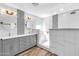 Elegant bathroom with a spacious double vanity, updated lighting, and a glass-enclosed shower at 20615 N 55Th Ave, Glendale, AZ 85308