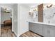 Bathroom featuring new vanity, wood-look flooring, and new light fixtures at 20615 N 55Th Ave, Glendale, AZ 85308