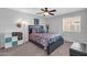 Bedroom featuring grey carpet, neutral walls, ceiling fan, and natural light at 20615 N 55Th Ave, Glendale, AZ 85308