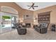 Comfortable living area with a fireplace and access to the outdoor patio via sliding glass doors, promoting indoor-outdoor flow at 20615 N 55Th Ave, Glendale, AZ 85308