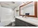 Bathroom featuring quartz vanity top, decorative wood mirror, and shower-tub combination at 2338 W Lindner Ave # 22, Mesa, AZ 85202