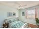 Comfortable bedroom featuring floral accents, a ceiling fan, and bright natural light at 2338 W Lindner Ave # 22, Mesa, AZ 85202