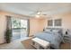Bright bedroom featuring sliding glass doors to outdoor area, stylish decor, and a ceiling fan at 2338 W Lindner Ave # 22, Mesa, AZ 85202