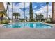 The community pool has lounge chairs and palm trees for a relaxing getaway at 2338 W Lindner Ave # 22, Mesa, AZ 85202