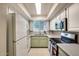Full kitchen with stainless steel appliances, light stone counters, and garden window at 2338 W Lindner Ave # 22, Mesa, AZ 85202