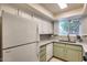 Well-lit kitchen featuring white appliances, stone countertops, and neutral backsplash at 2338 W Lindner Ave # 22, Mesa, AZ 85202