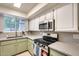 Bright kitchen featuring modern stainless steel appliances, stone countertops, and stylish backsplash at 2338 W Lindner Ave # 22, Mesa, AZ 85202