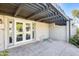 This covered patio includes white framed glass doors and a view of the lake at 2338 W Lindner Ave # 22, Mesa, AZ 85202