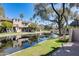 Waterfront condos with balconies and palm trees are reflected in the waterway at 2338 W Lindner Ave # 22, Mesa, AZ 85202