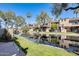 Condos with balconies are reflected in the waterway and surrounded by palm trees at 2338 W Lindner Ave # 22, Mesa, AZ 85202