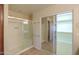 Well lit bathroom with tile floor, glass shower, and large closet with mirror doors at 2433 E Hancock Trl, Casa Grande, AZ 85194