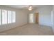 Spacious main bedroom with ample natural light, plush carpets, and neutral walls at 2433 E Hancock Trl, Casa Grande, AZ 85194