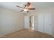 Inviting bedroom featuring plush carpets, and a ceiling fan for added comfort at 2433 E Hancock Trl, Casa Grande, AZ 85194