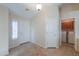 Inviting foyer featuring tile floors and natural light with convenient access to laundry room at 2433 E Hancock Trl, Casa Grande, AZ 85194