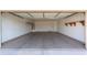 Spacious two car garage with shelving, water heater, and access door at 2433 E Hancock Trl, Casa Grande, AZ 85194