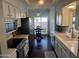 Bright kitchen featuring white cabinetry, modern appliances, and an adjacent dining area at 2905 E Montecito Ave, Phoenix, AZ 85016