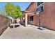 Backyard patio area with brick pavers, covered patio, basketball hoop, and mature tree at 314 N 79Th Pl, Mesa, AZ 85207