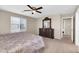 Carpeted bedroom with a large dresser, ceiling fan, and lots of natural light at 314 N 79Th Pl, Mesa, AZ 85207