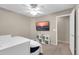 Bedroom featuring a ceiling fan, large window, television, and daybed at 314 N 79Th Pl, Mesa, AZ 85207