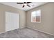 Neutral bedroom featuring tile floors, ceiling fan, window, and closet at 314 N 79Th Pl, Mesa, AZ 85207