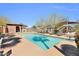 Community pool surrounded by lounge chairs and shade structures at 314 N 79Th Pl, Mesa, AZ 85207