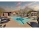 Community pool surrounded by lounge chairs and shade structures at 314 N 79Th Pl, Mesa, AZ 85207