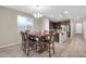 Bright dining area featuring a wooden table set and direct access to the modern kitchen at 314 N 79Th Pl, Mesa, AZ 85207