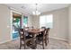 Well-lit dining area with a sliding glass door to outdoor patio and backyard at 314 N 79Th Pl, Mesa, AZ 85207