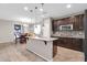 Modern kitchen with island, pendant lighting, dark cabinetry, and stainless appliances at 314 N 79Th Pl, Mesa, AZ 85207