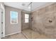 Bathroom featuring spacious tiled shower with a glass enclosure, window, and built-in shelf at 314 N 79Th Pl, Mesa, AZ 85207