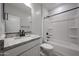 Bright bathroom featuring granite countertop, updated fixtures, and a combined bathtub and shower at 35295 W La Paz St, Maricopa, AZ 85138