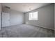 A carpeted bedroom features a window that lets in natural light at 35295 W La Paz St, Maricopa, AZ 85138