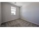 Cozy bedroom showcasing neutral walls, soft carpet, and natural light from a window at 35295 W La Paz St, Maricopa, AZ 85138