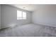 A carpeted bedroom features a window that lets in natural light at 35295 W La Paz St, Maricopa, AZ 85138